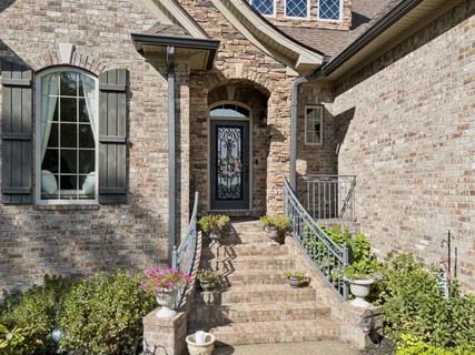 a front view of a house with potted plants