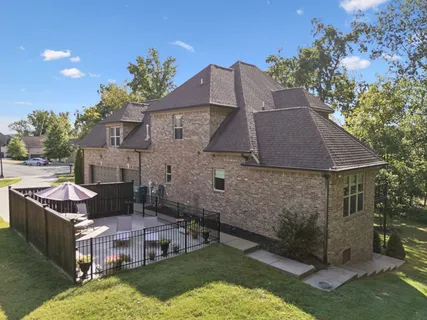an aerial view of a house with a garden and swimming pool