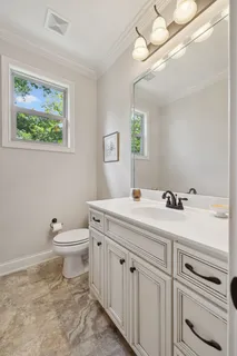 a bathroom with a toilet a sink and mirror