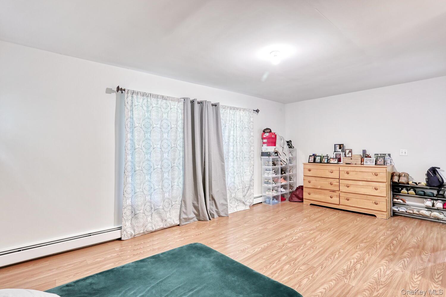 329 Call Hollow Road Haverstraw, NY 10980 - Photo 12 of 28 Bedroom with wood finished floors and a baseboard heating unit