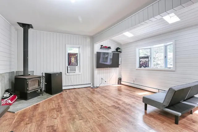 a bedroom with furniture and a flat screen tv