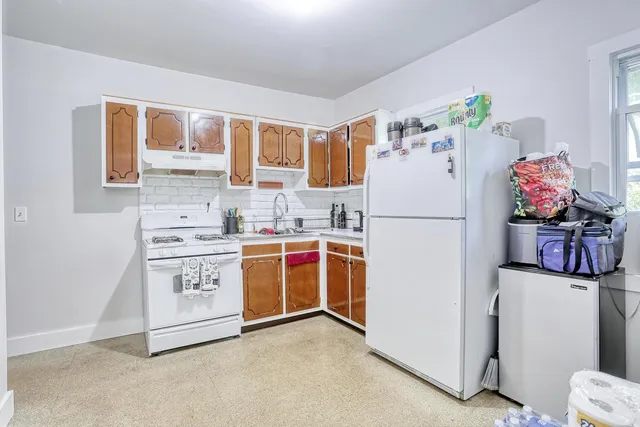 a white refrigerator freezer sitting in a kitchen