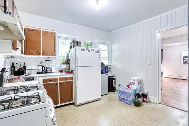 a kitchen with stainless steel appliances a refrigerator and a stove top oven