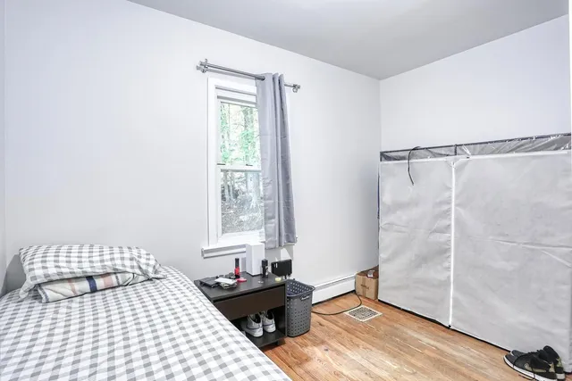 a bedroom with a bed and a window