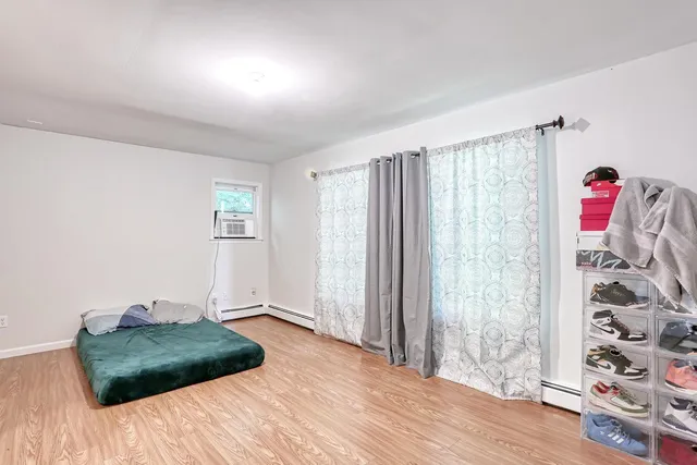 a bedroom with a bed and a window