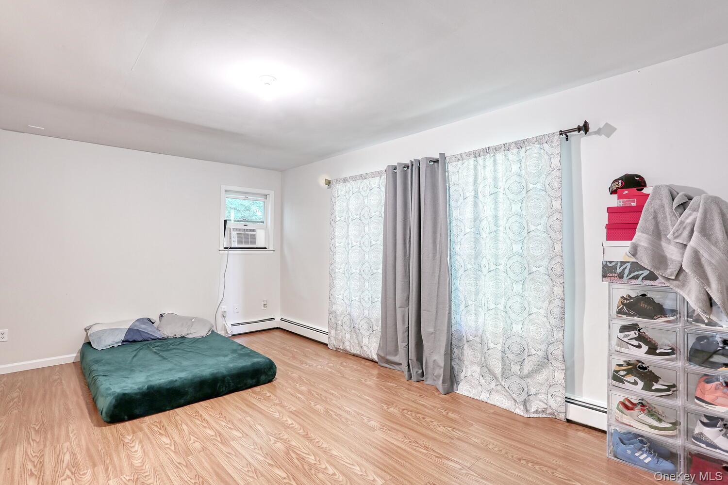 329 Call Hollow Road Haverstraw, NY 10980 - Photo 10 of 28 Sitting room with wood finished floors, a baseboard heating unit, and cooling unit