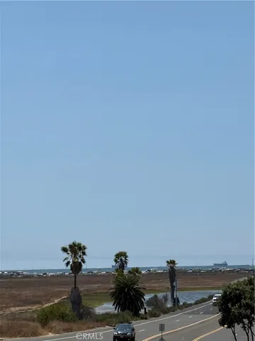a bedroom with a bed painting and a window