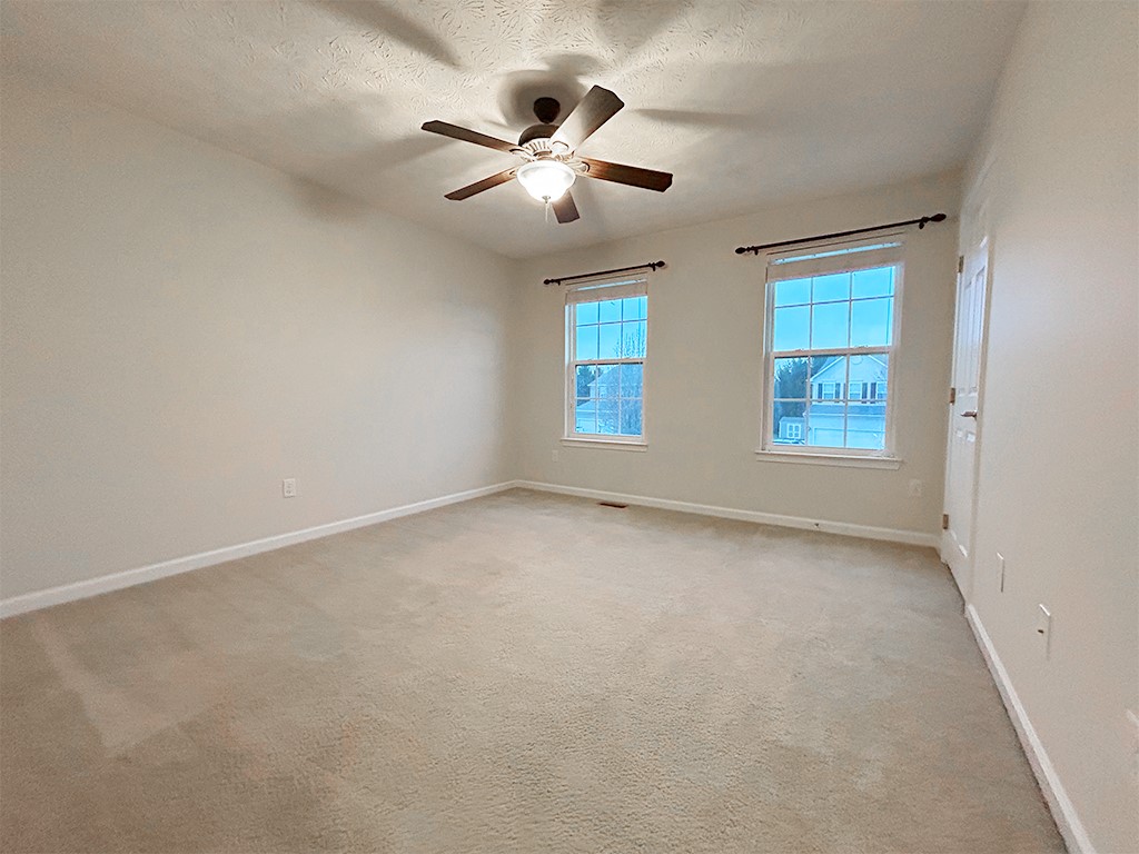 1978 Spring Ridge Drive Xenia, OH 45385 - Photo 24 of 44 This spacious bedroom offers abundant natural light and comfortable carpeting, creating a serene retreat.