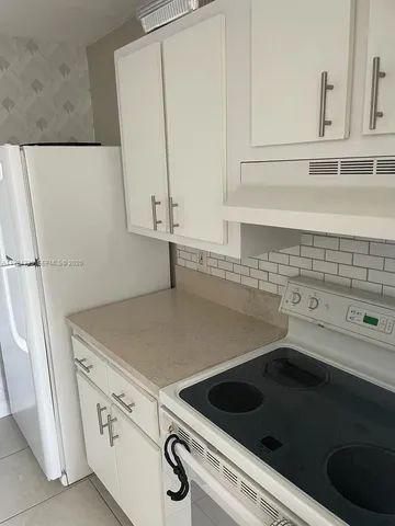a view of a storage and utility room with washer and dryer