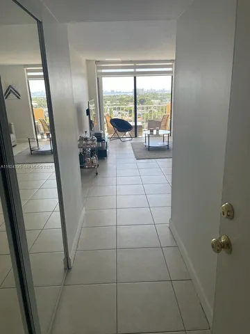 a hallway with sliding door and glass windows