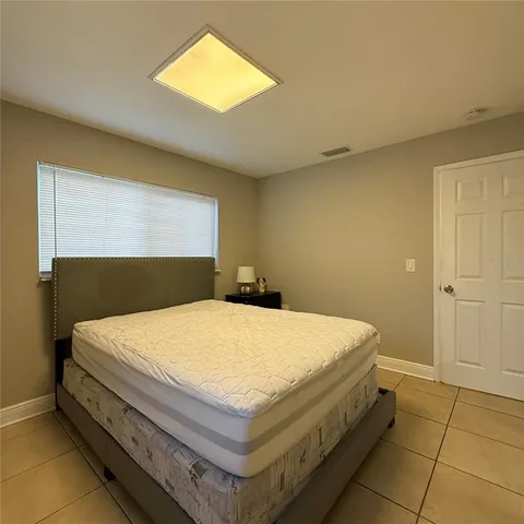 a bedroom with a bed and a night stand