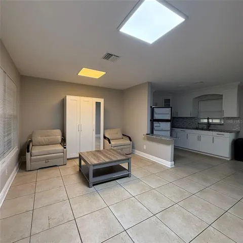 a view of a dining room with furniture and a window
