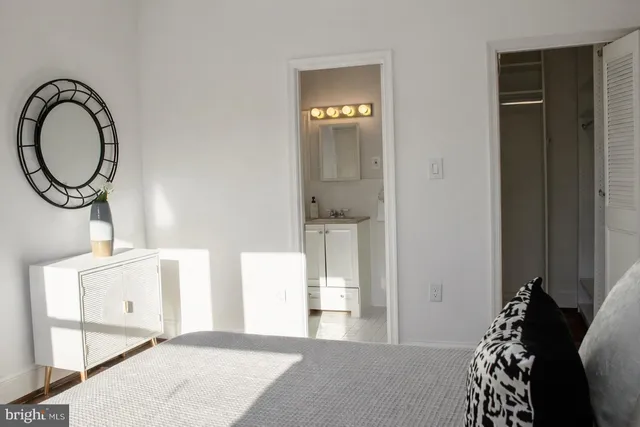 a bedroom with a bed and a mirror