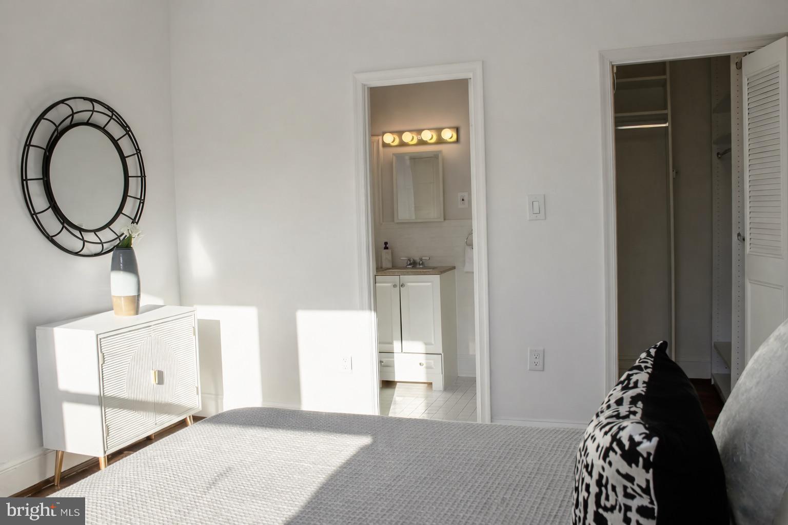 3616 Connecticut Avenue Northwest, Unit 408 Washington, DC 20008 - Photo 11 of 16 a bedroom with a bed and a mirror