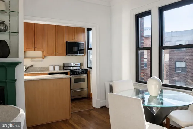 a kitchen with a table chairs and a refrigerator