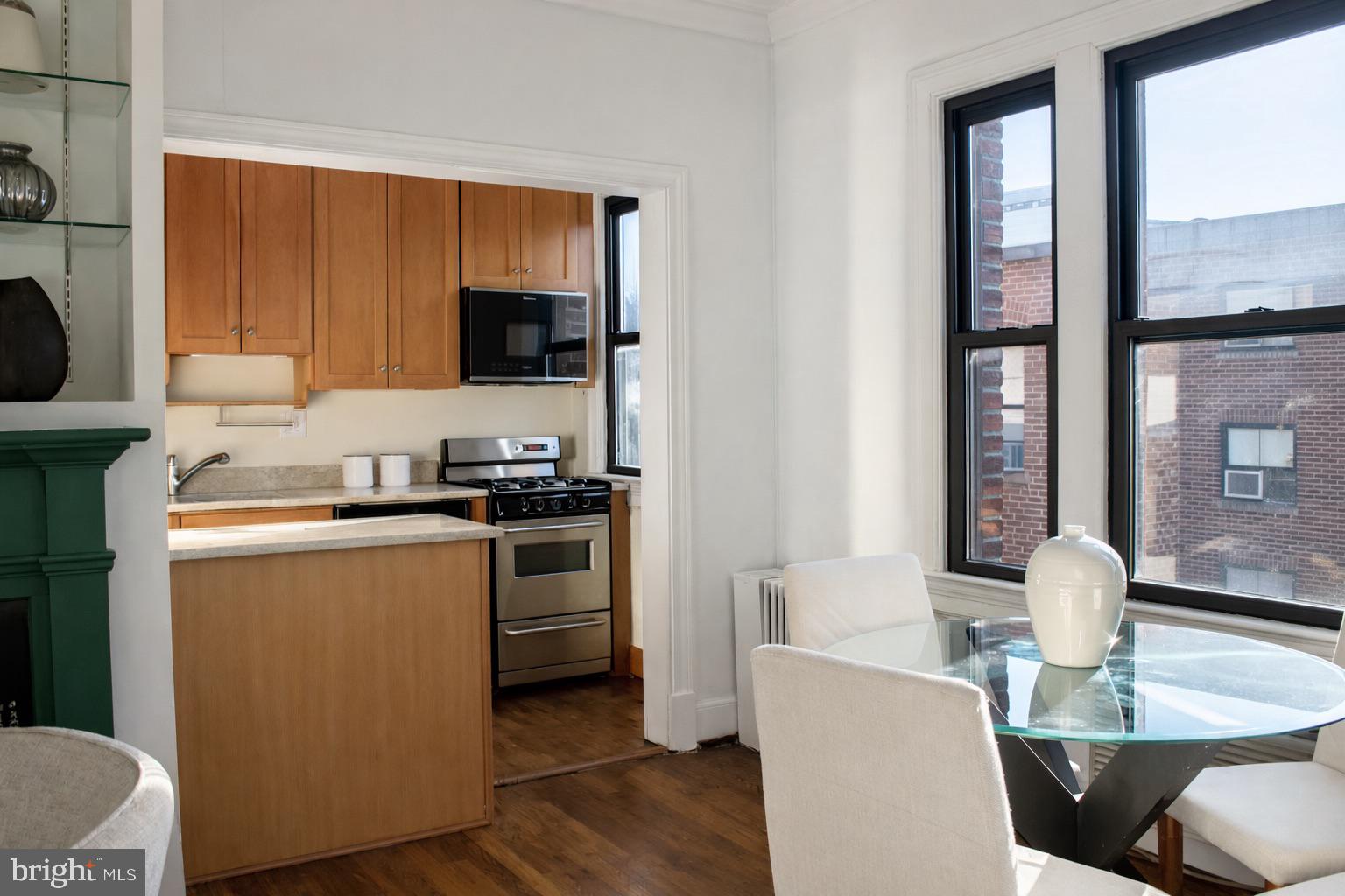 3616 Connecticut Avenue Northwest, Unit 408 Washington, DC 20008 - Photo 5 of 16 a kitchen with a table chairs and a refrigerator