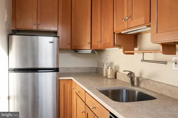 a kitchen with refrigerator a microwave and sink