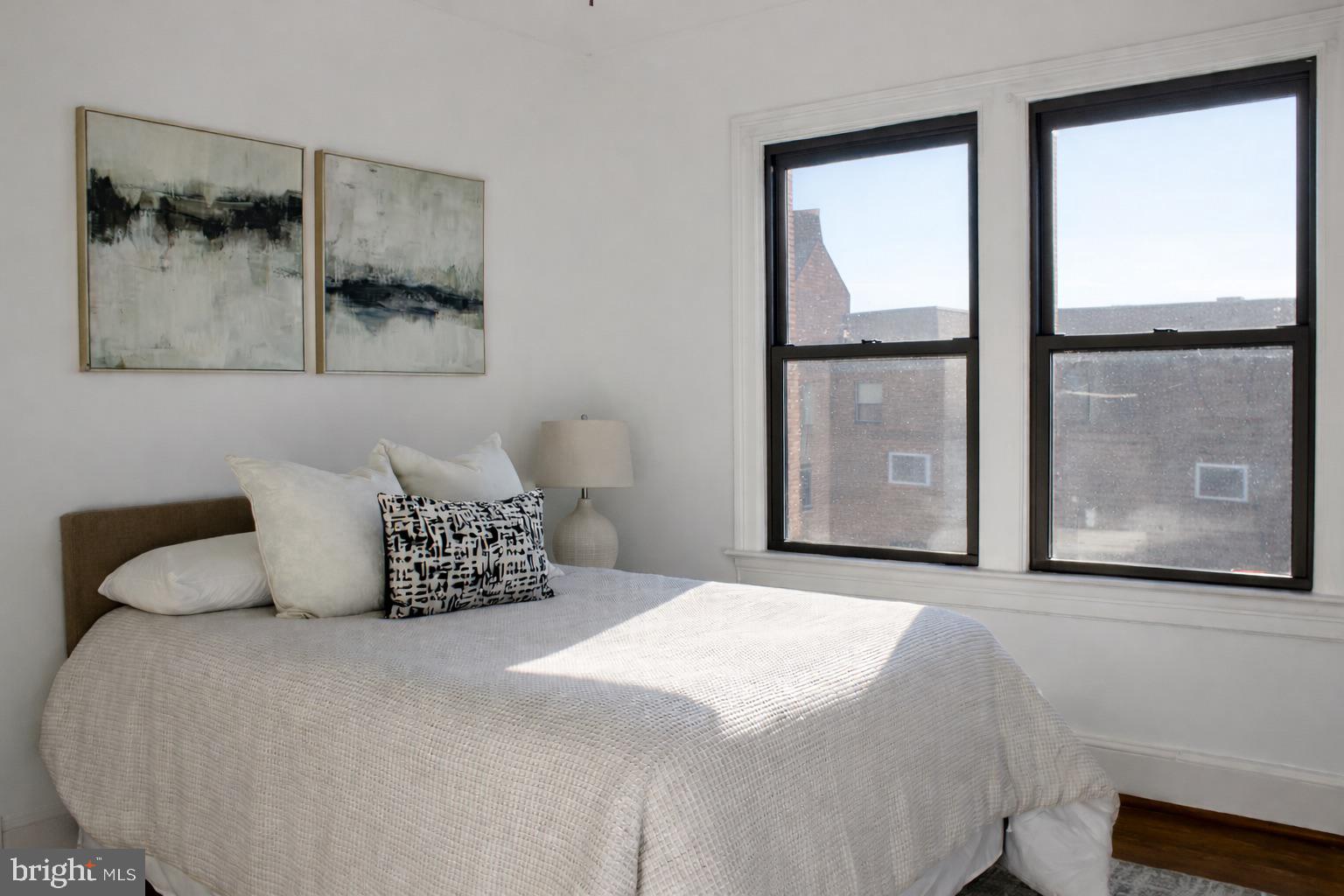 3616 Connecticut Avenue Northwest, Unit 408 Washington, DC 20008 - Photo 9 of 16 a bedroom with a large bed and a large window