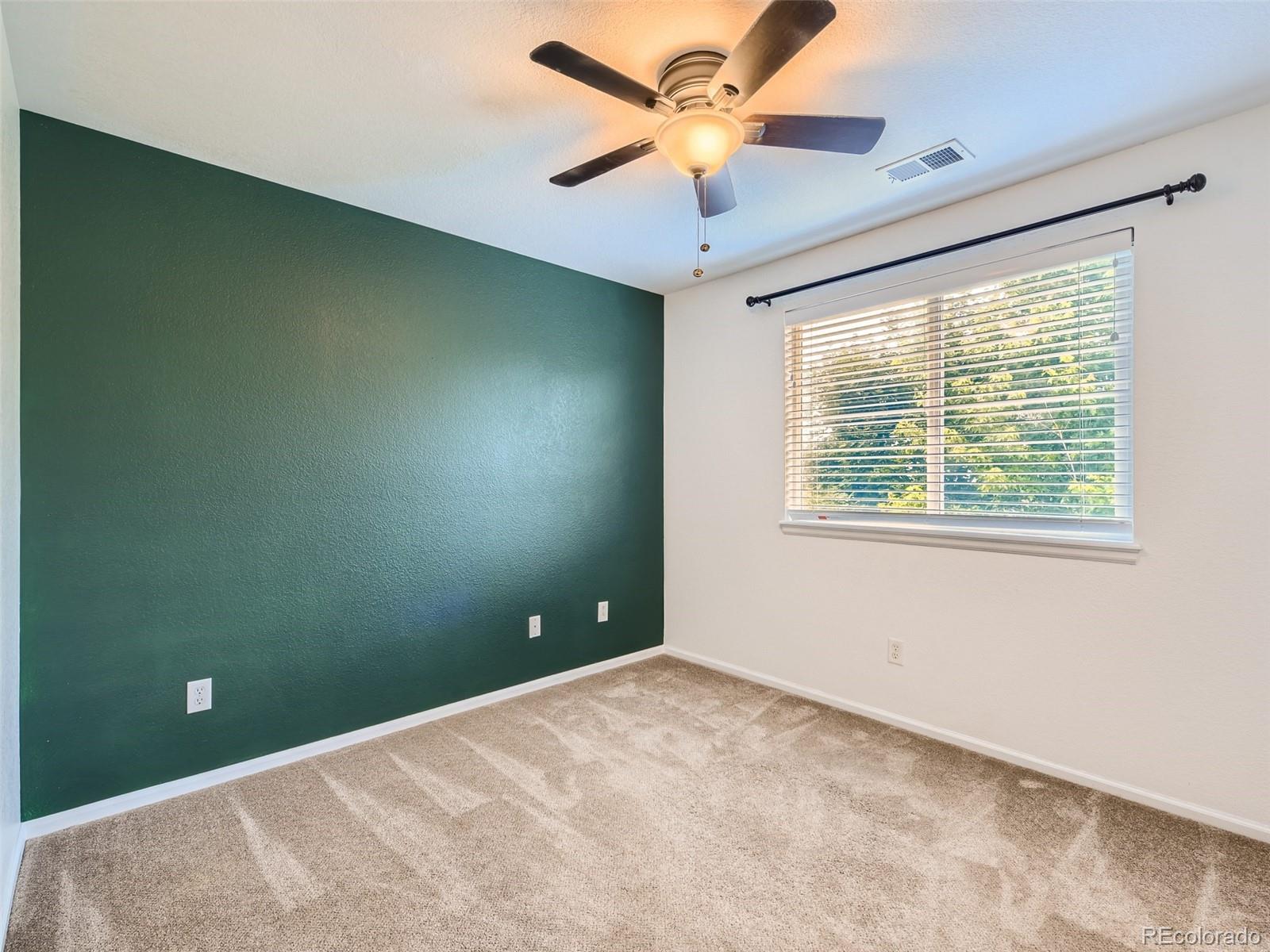 10574 Tracewood Circle Highlands Ranch, CO 80130 - Photo 13 of 21 a view of a big room with windows and chandelier fan