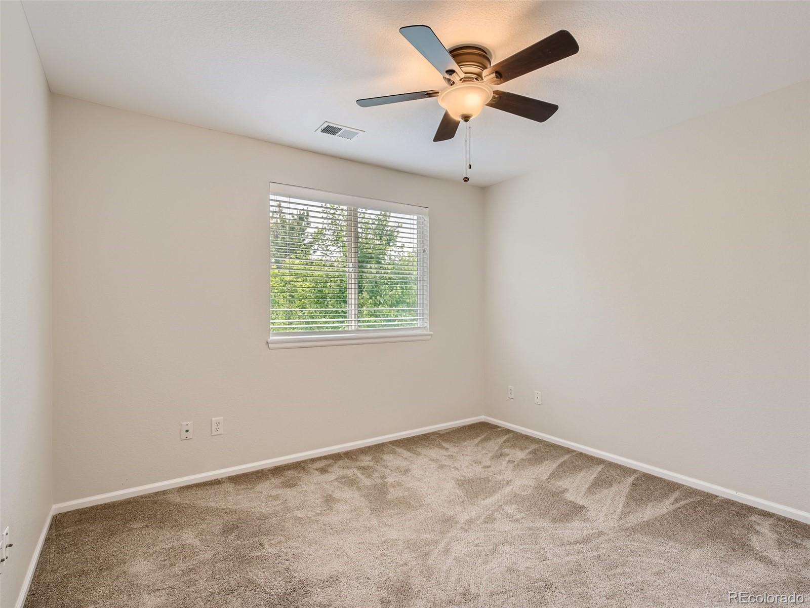 10574 Tracewood Circle Highlands Ranch, CO 80130 - Photo 15 of 21 an empty room with a window and a fan