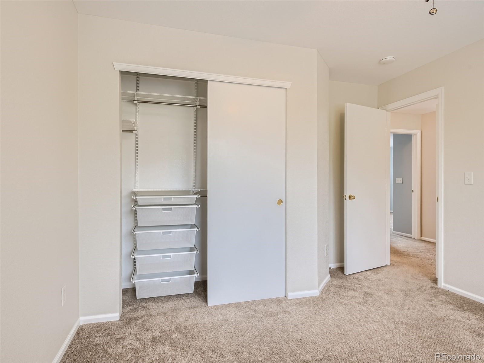 10574 Tracewood Circle Highlands Ranch, CO 80130 - Photo 16 of 21 a view of walk in closet with empty racks