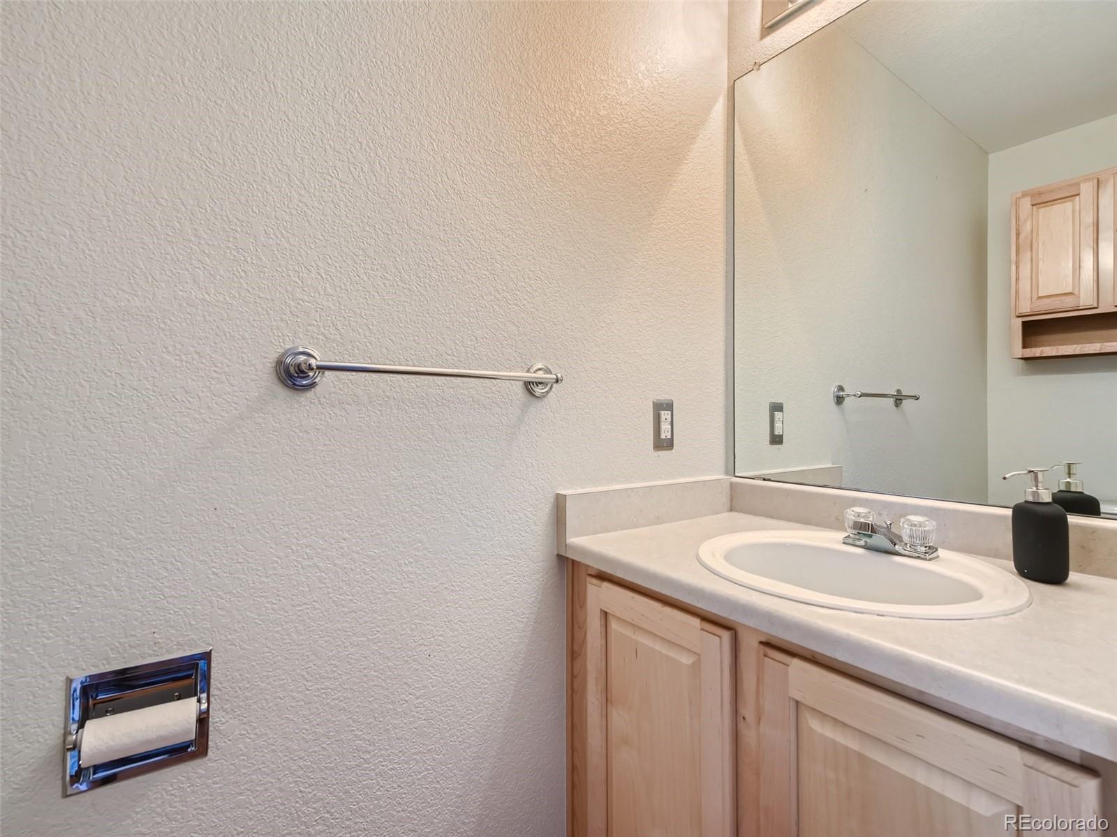 10574 Tracewood Circle Highlands Ranch, CO 80130 - Photo 18 of 21 a bathroom with a sink and a mirror