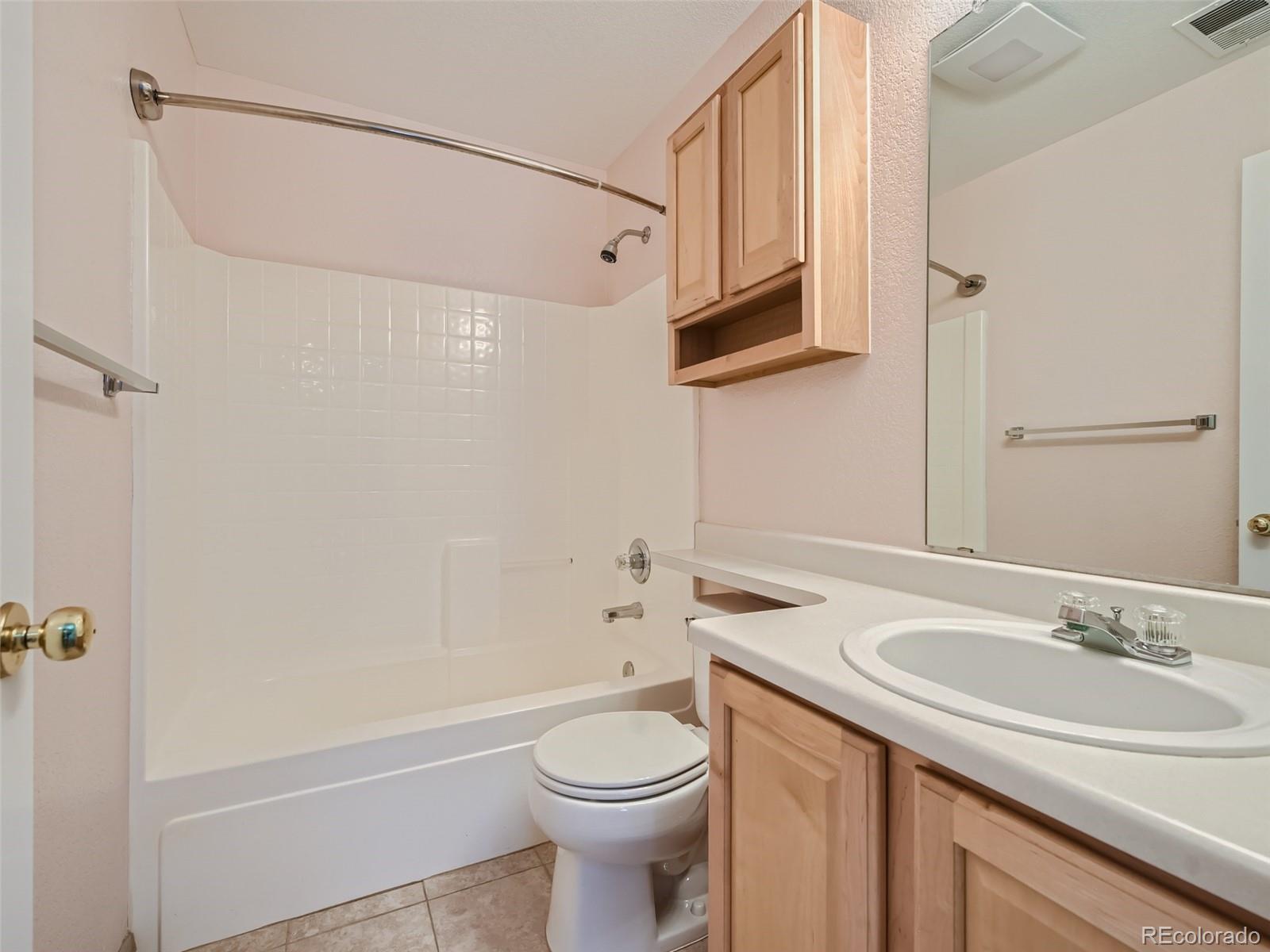 10574 Tracewood Circle Highlands Ranch, CO 80130 - Photo 19 of 21 a bathroom with a sink a toilet and shower