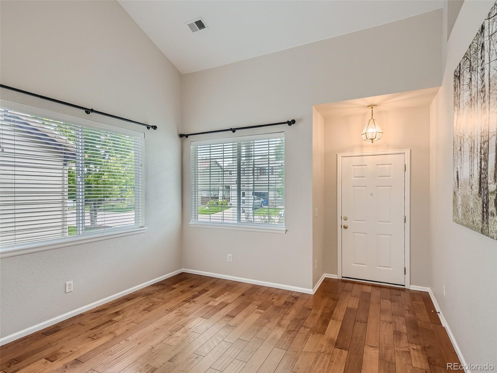 10574 Tracewood Circle Highlands Ranch, CO 80130 - Photo 4 of 21 a view of an empty room with wooden floor and a window