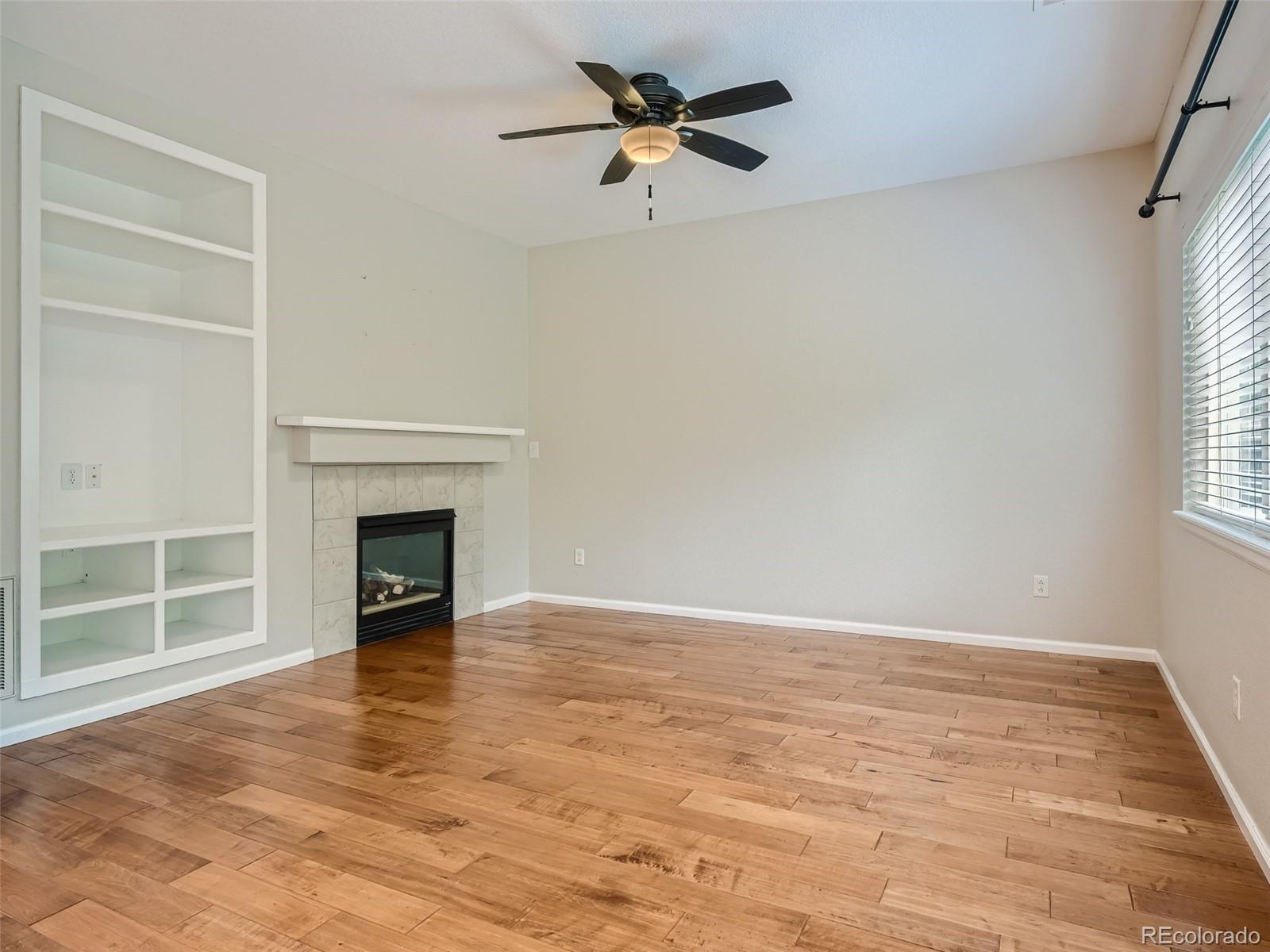 10574 Tracewood Circle Highlands Ranch, CO 80130 - Photo 8 of 21 wooden floor in an empty room with a window