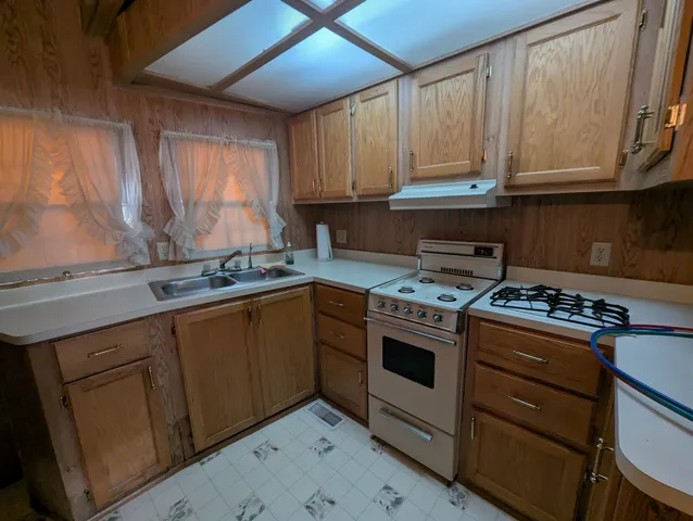 a kitchen with stainless steel appliances granite countertop a stove and a sink
