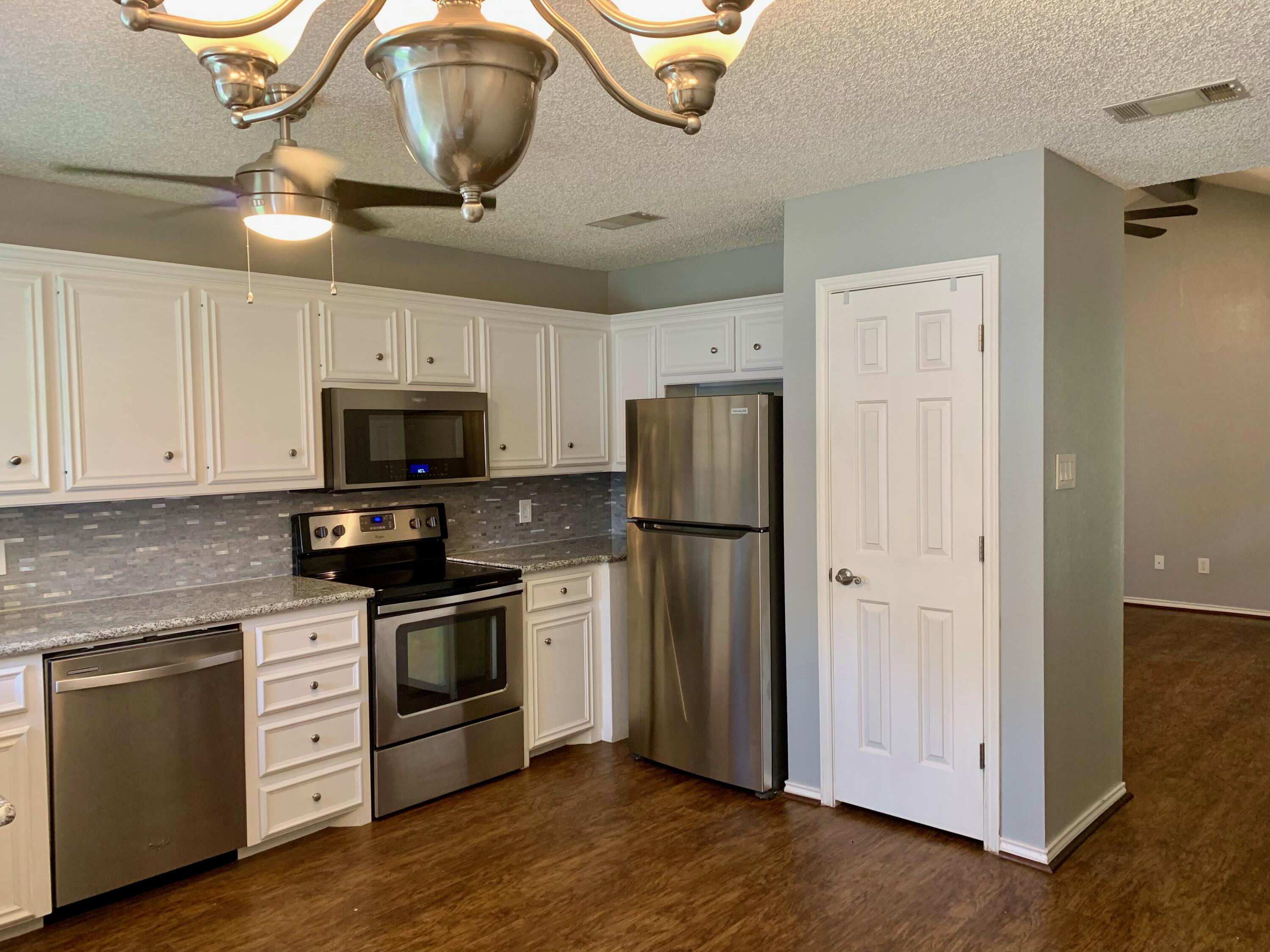 8904 Elgin Avenue Lubbock, TX 79423 - Photo 1 of 20 a kitchen with stainless steel appliances a refrigerator a stove a microwave and cabinets