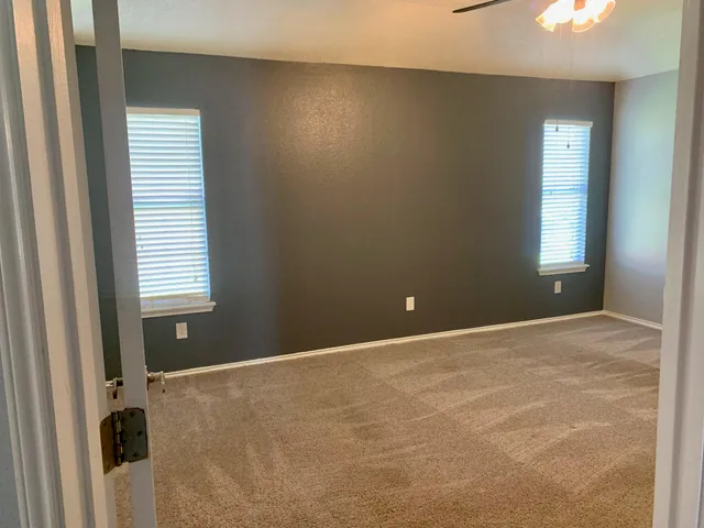 a view of an empty room with a window