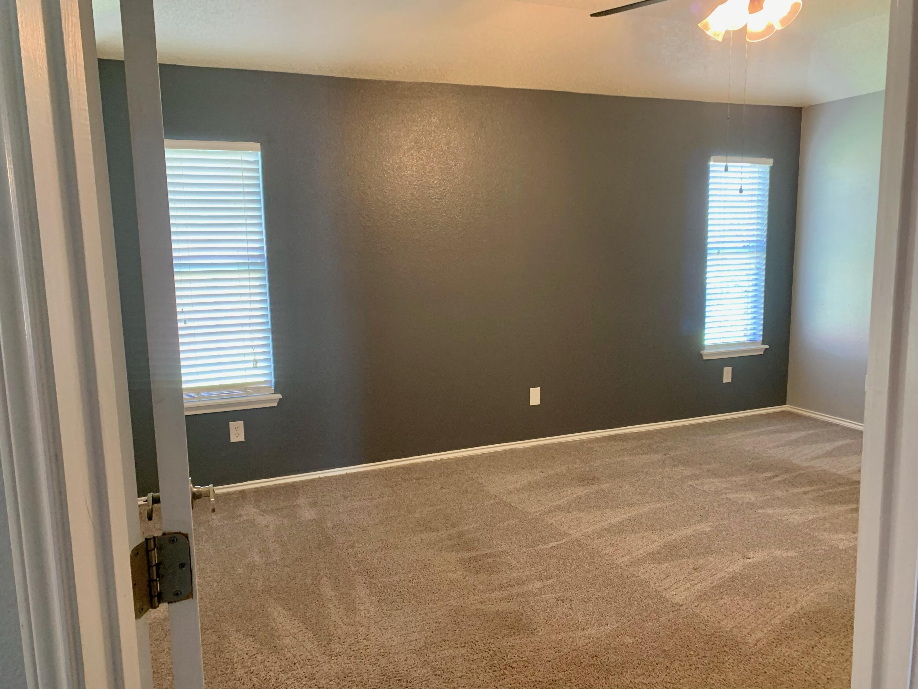 8904 Elgin Avenue Lubbock, TX 79423 - Photo 15 of 20 a view of an empty room with a window