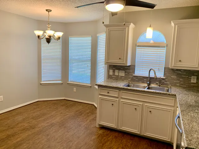 a bathroom with a sink and a window