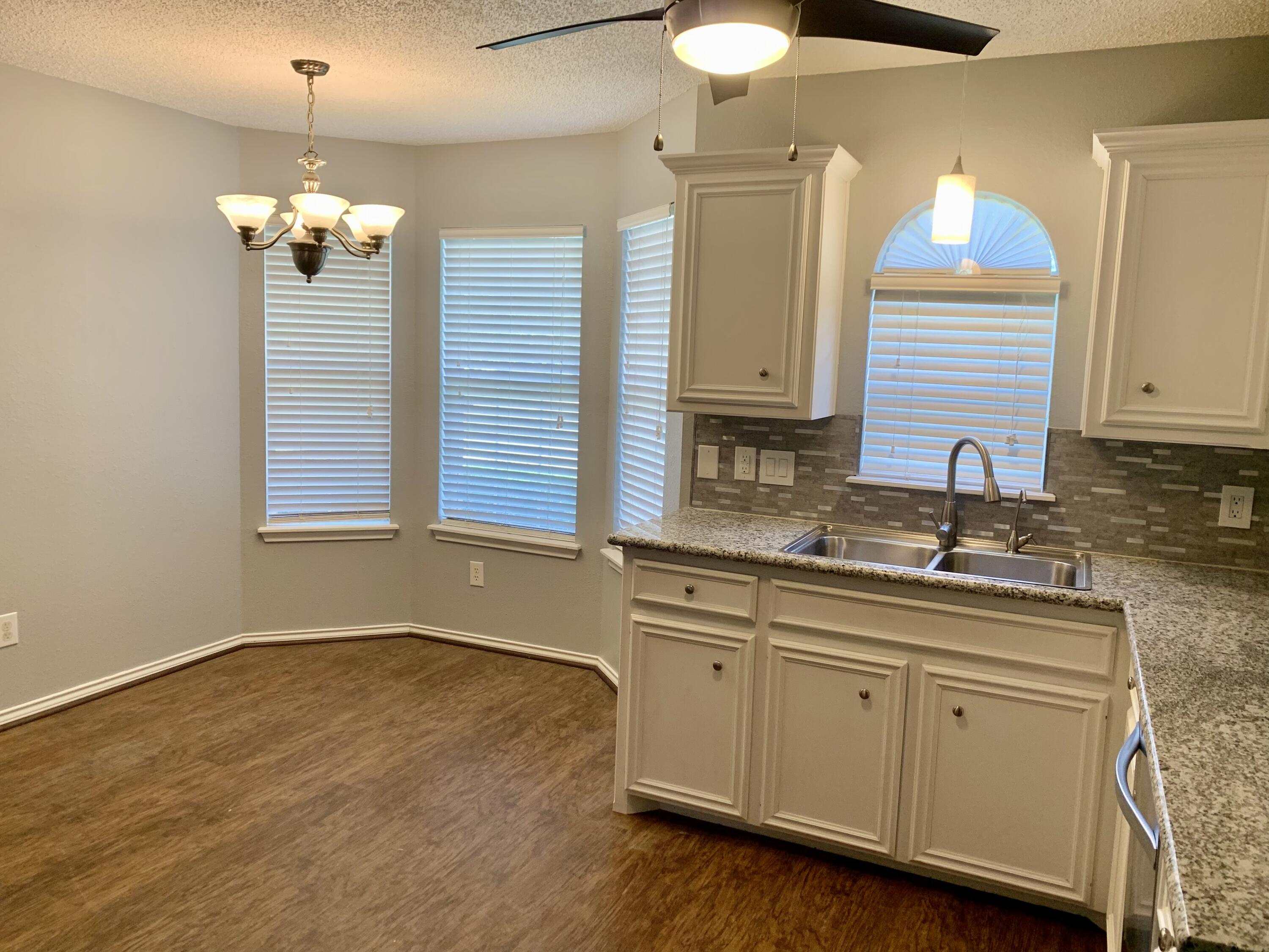 8904 Elgin Avenue Lubbock, TX 79423 - Photo 3 of 20 a bathroom with a sink and a window