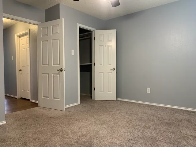 an empty room with closet area