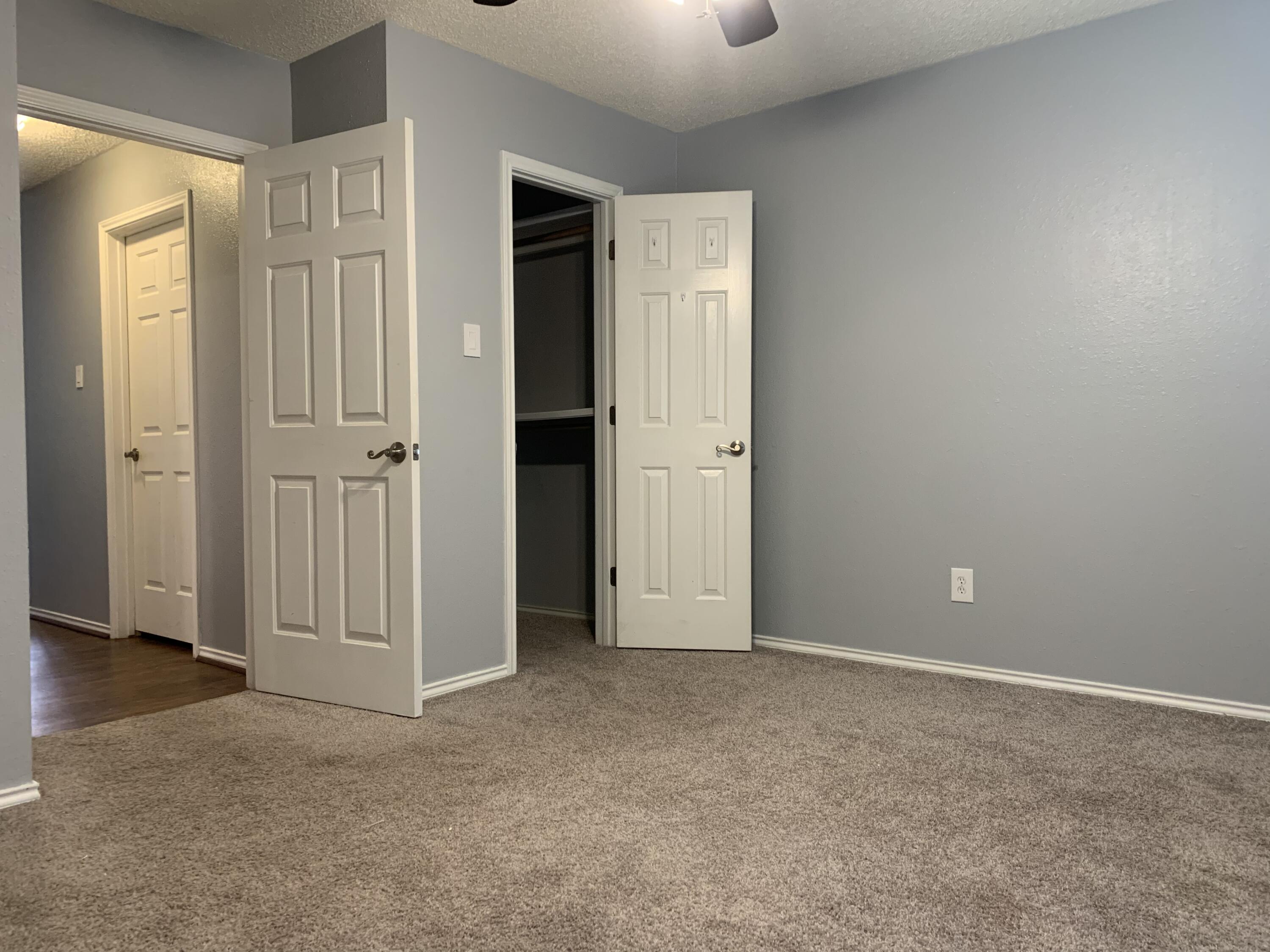 8904 Elgin Avenue Lubbock, TX 79423 - Photo 8 of 20 an empty room with closet area