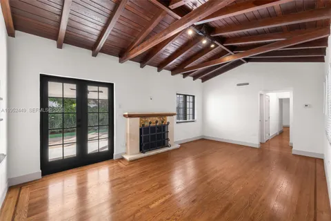 an aerial view of residential houses with outdoor space and trees