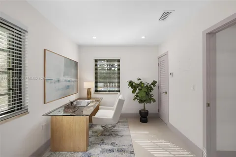 a kitchen with stainless steel appliances white cabinets and a stove top oven