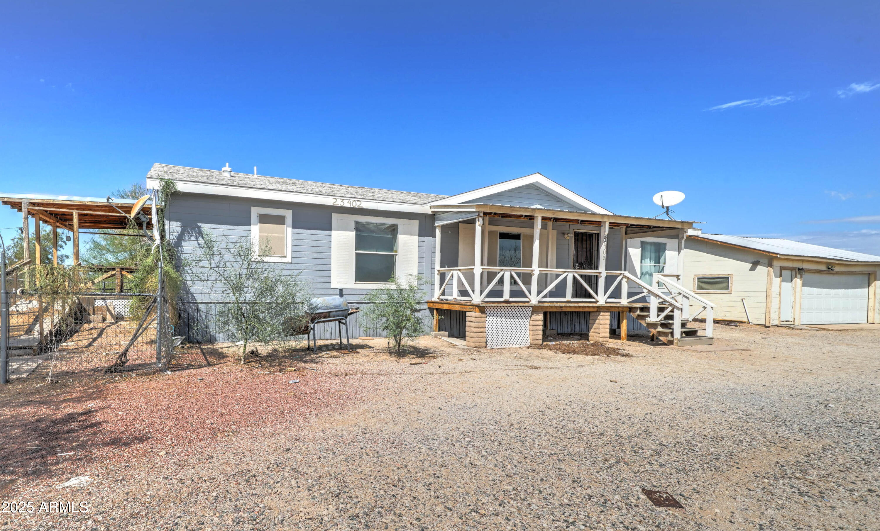 a view of a house with a patio and a yard