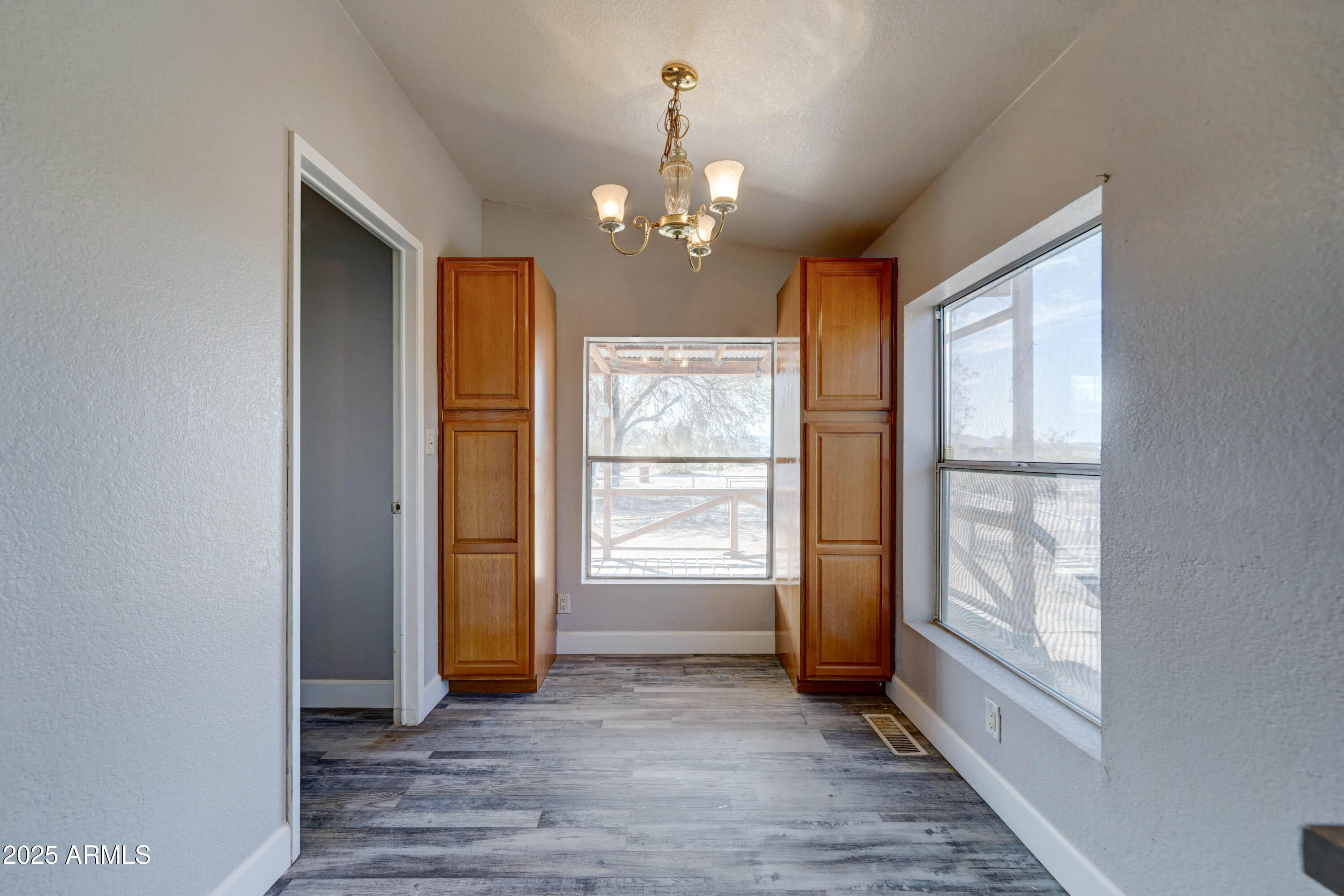 23402 South Manzanilla Road Buckeye, AZ 85326 - Photo 13 of 46 a view of an empty room with window and cabinet