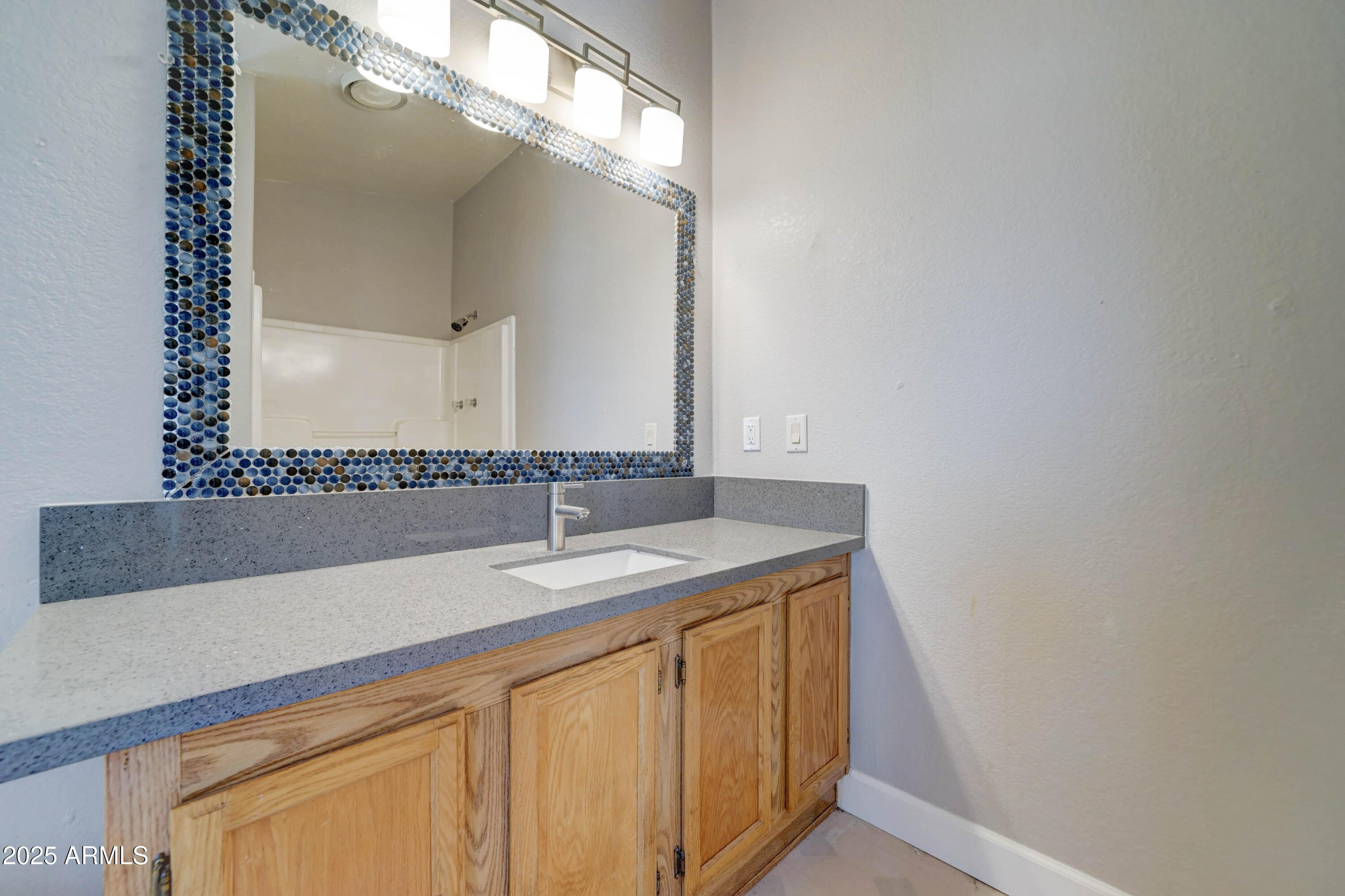 23402 South Manzanilla Road Buckeye, AZ 85326 - Photo 16 of 46 a bathroom with a sink and a mirror