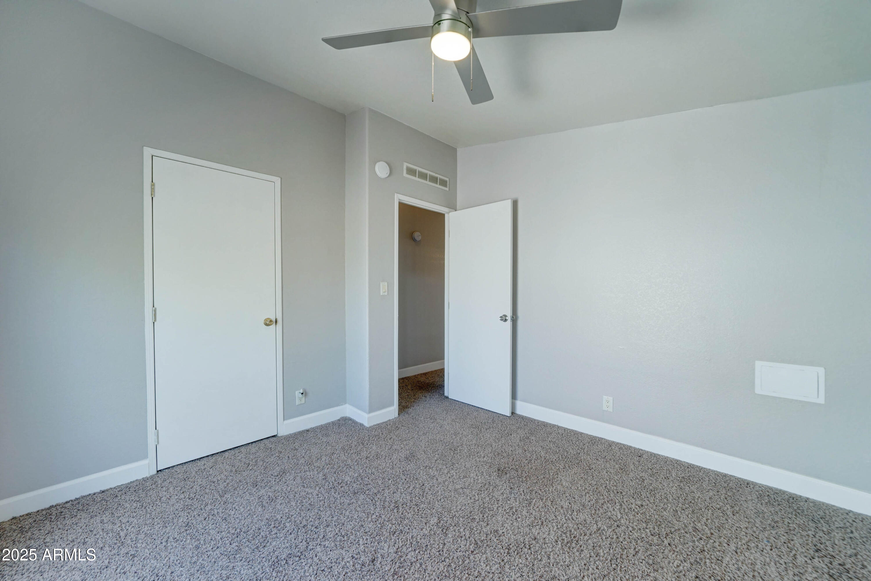 23402 South Manzanilla Road Buckeye, AZ 85326 - Photo 19 of 46 an empty room with a ceiling fan and a window