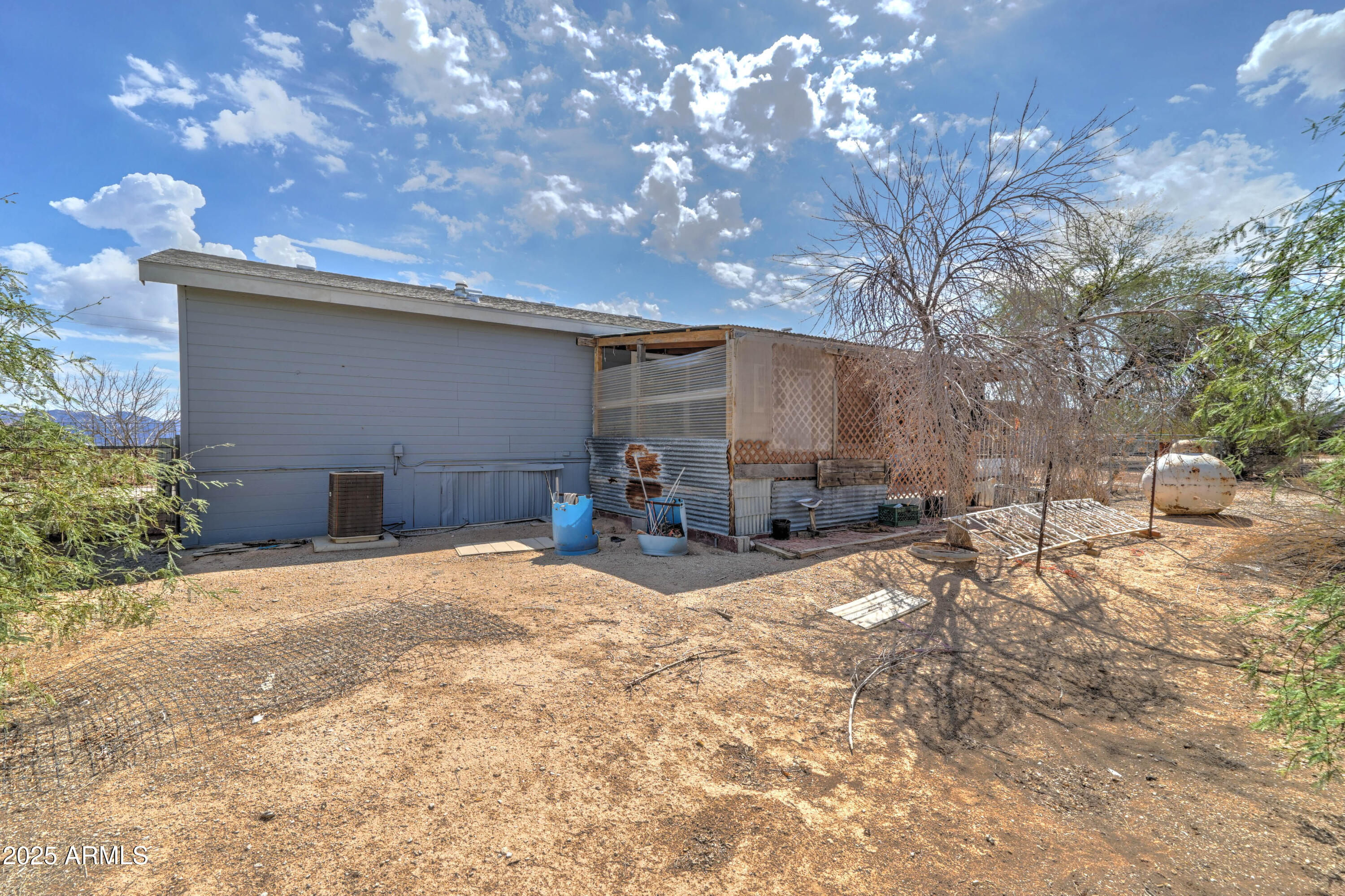 23402 South Manzanilla Road Buckeye, AZ 85326 - Photo 27 of 46 a backyard of a house with table and chairs and potted plants