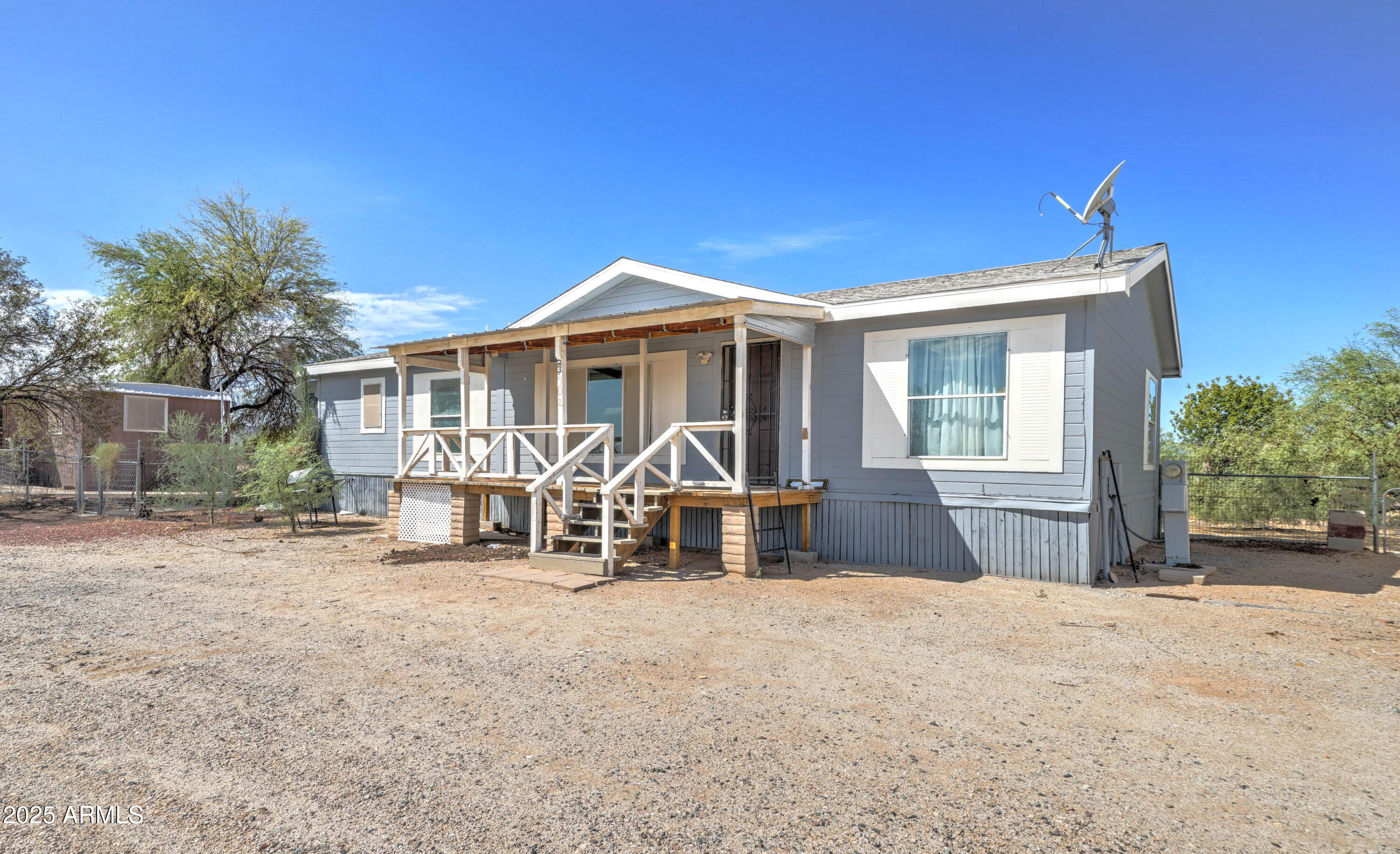 23402 South Manzanilla Road Buckeye, AZ 85326 - Photo 3 of 46 a front view of a house with a yard outdoor seating and barbeque oven