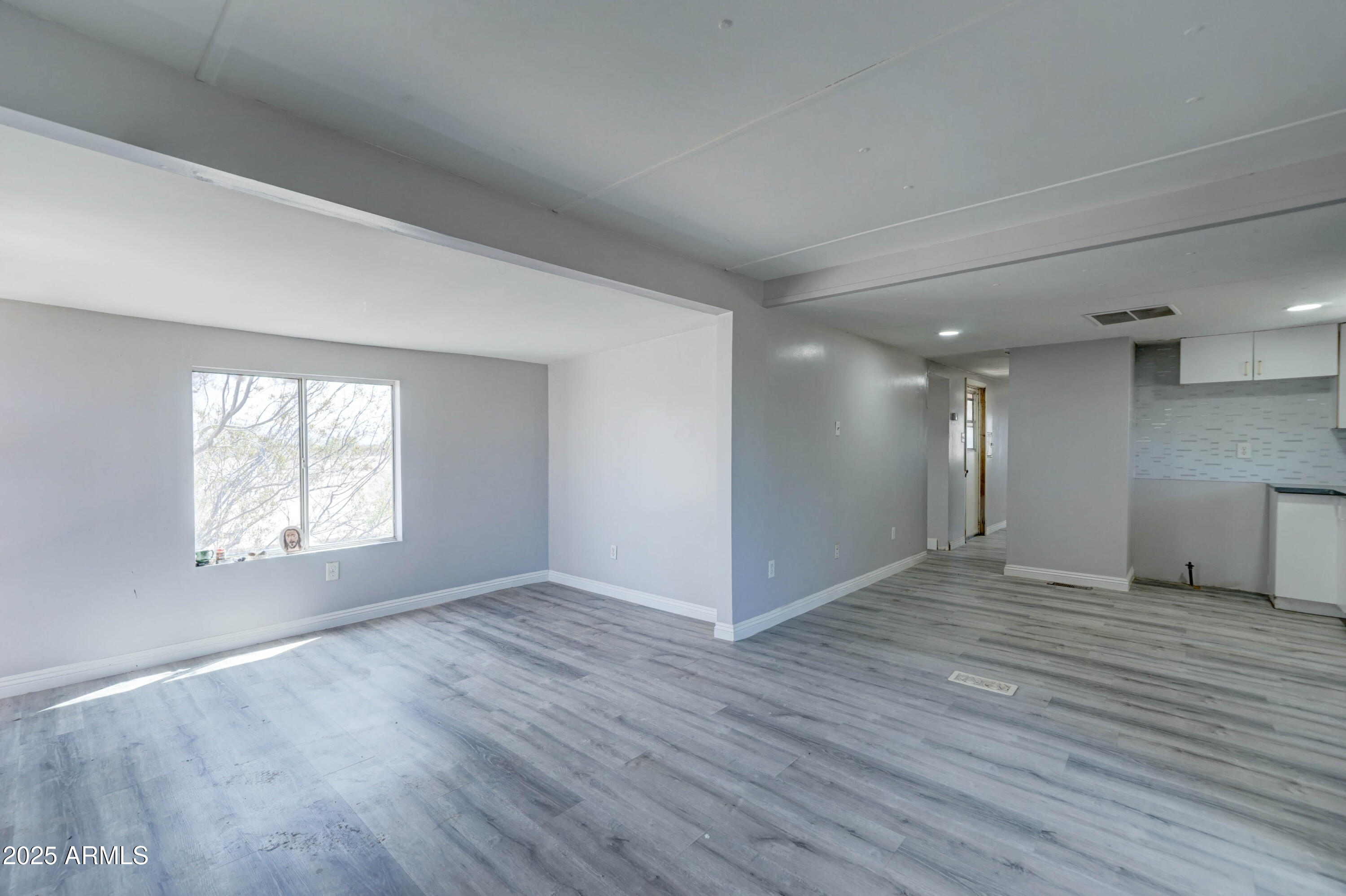 23402 South Manzanilla Road Buckeye, AZ 85326 - Photo 31 of 46 an empty room with wooden floor and windows