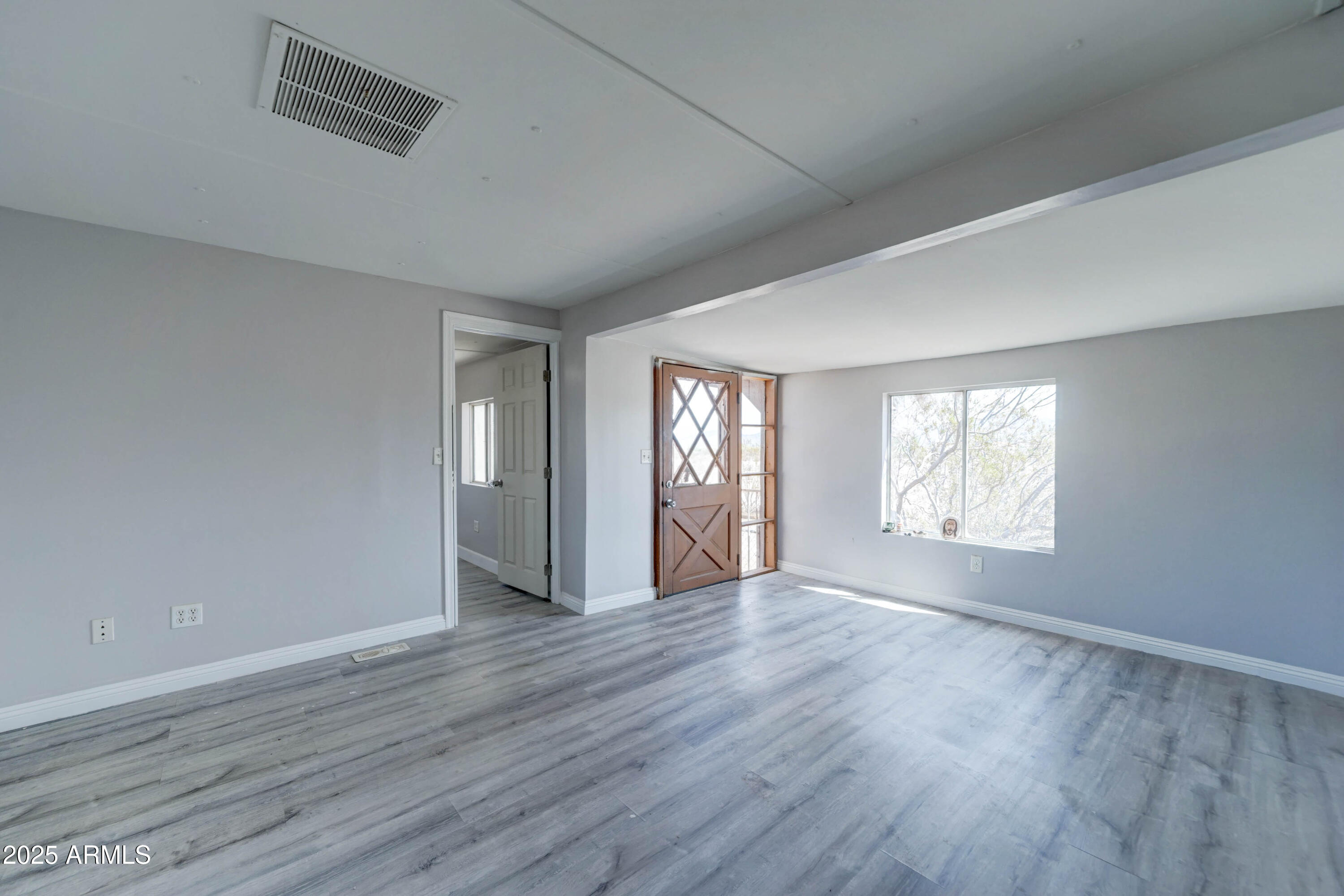 23402 South Manzanilla Road Buckeye, AZ 85326 - Photo 32 of 46 a view of an empty room with wooden floor and a window