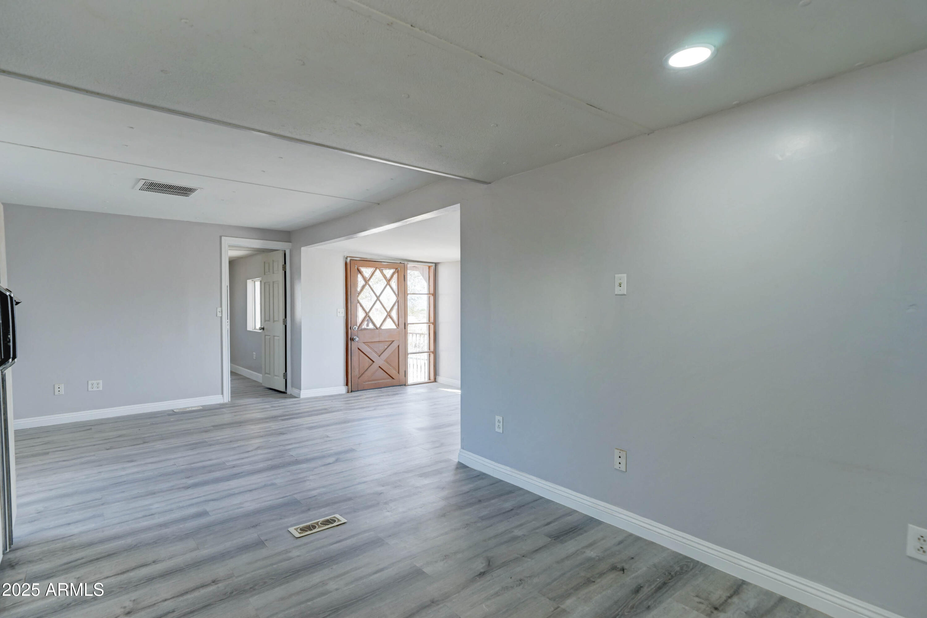 23402 South Manzanilla Road Buckeye, AZ 85326 - Photo 36 of 46 a view of an empty room with window and wooden floor