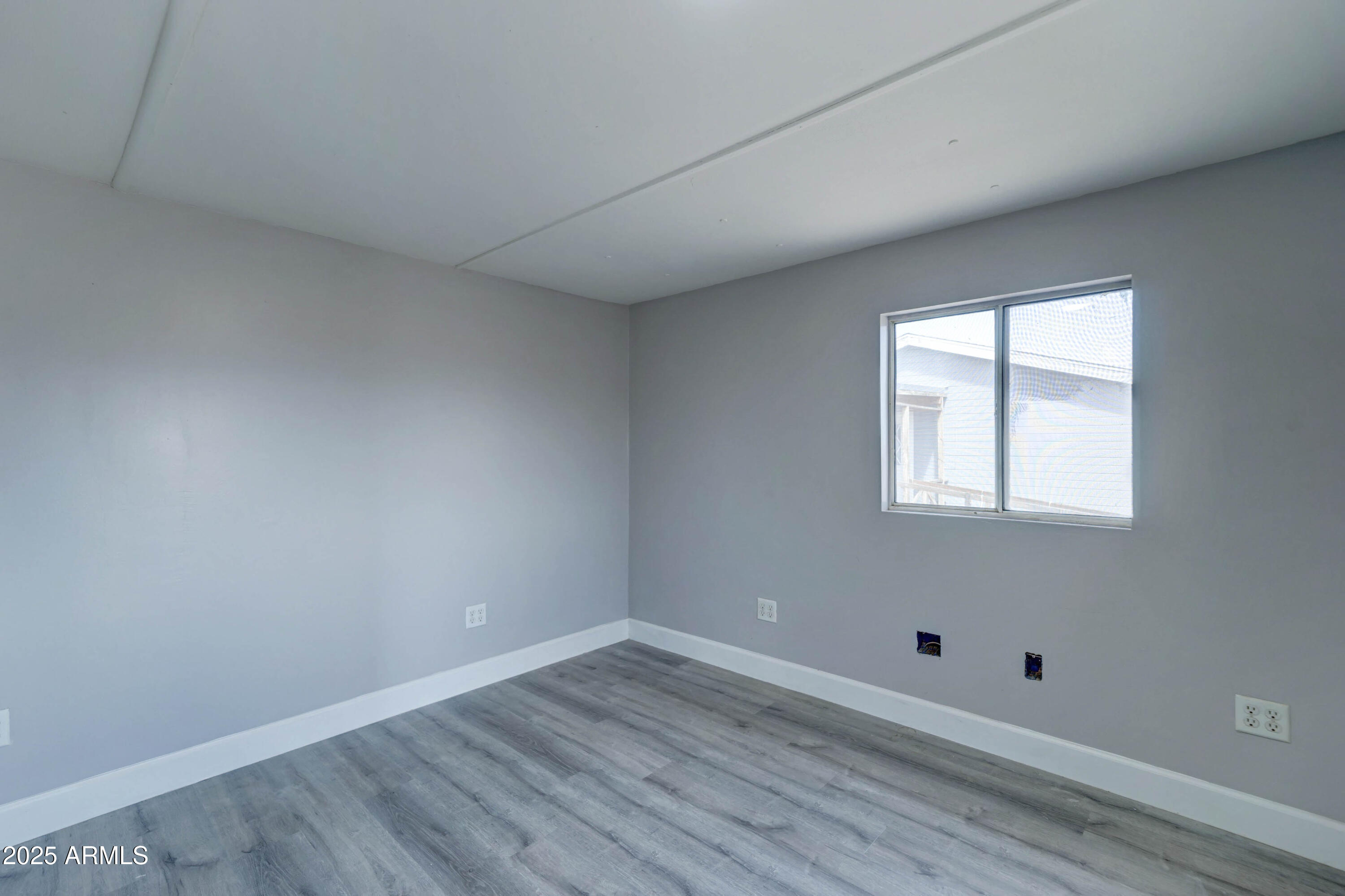 23402 South Manzanilla Road Buckeye, AZ 85326 - Photo 37 of 46 an empty room with wooden floor and windows