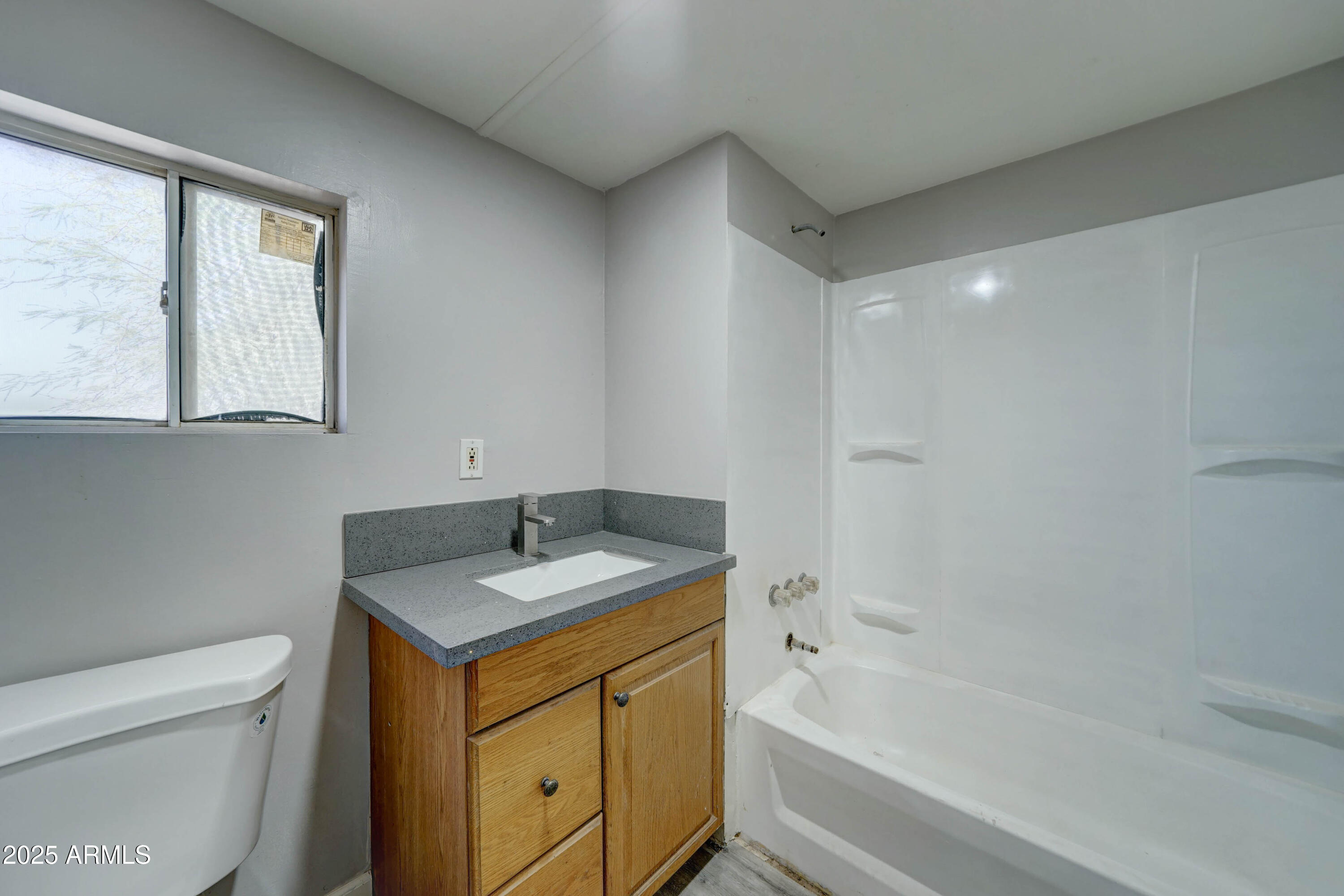 23402 South Manzanilla Road Buckeye, AZ 85326 - Photo 38 of 46 a bathroom with a granite countertop sink toilet and bathtub